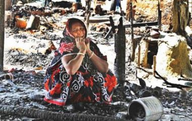 Having lost everything, Nipu Sheel wails sitting on the debris of her house that was set ablaze by Jamaat-Shibir men at Banshkhali in Chittagong. The religious fanatics looted and torched houses and temples of the Hindus in the district on February 28.