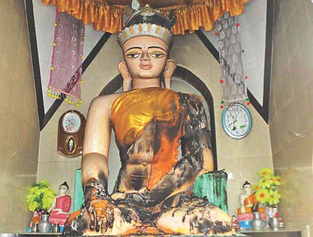 Criminals torched the Buddha idol in Shakyamuni pagoda of Boalkhali in Chittagong after breaking into the monastery early yesterday. They burnt its robe but managed to make way with five smaller idols and the donation box. Photo: Star