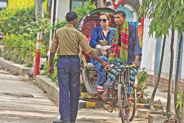 A lungi clad rickshaw puller stopped at the entry of Baridhara in the capital yesterday. Security workers do not let rickshaw pullers in lungi into the posh neighbourhood following instructions from the association of Baridhara home owners. Photo: Star