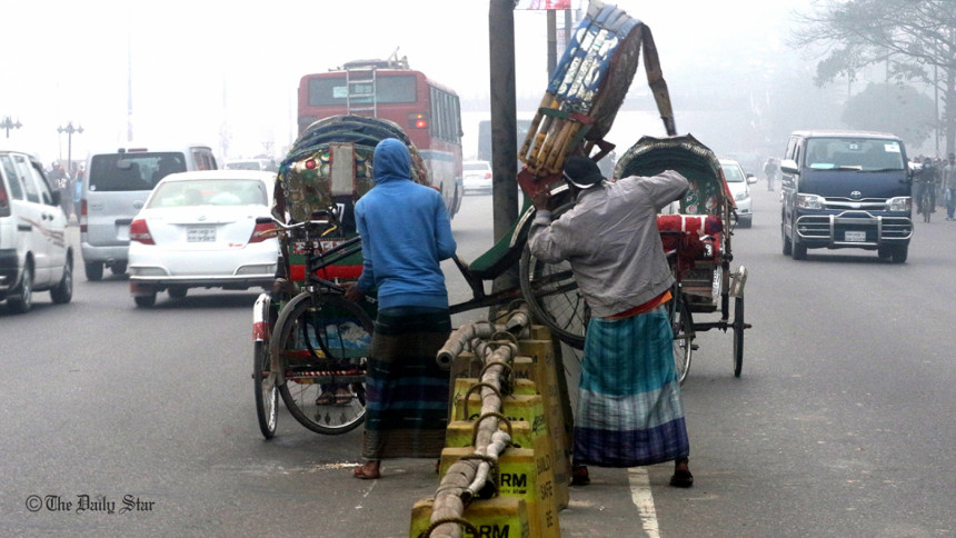 A rickshaw is being carried across A rickshaw is being carried across