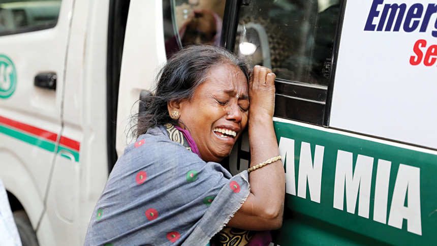 Death came draped in smoke Sheuli Das weeps as she holds onto the ambulance carrying the bodies of her niece Poppy Roy and two grandchildren, after they died in a fire on Bailey Road in the capital on Thursday night.
