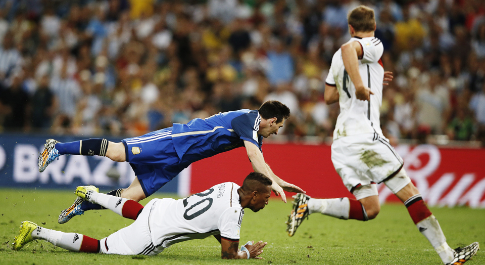 Argentina's forward Lionel Messi (up) vies with Germany's defender Jerome Boateng during the final football match between Germany and Argentina for the FIFA World Cup at The Maracana Stadium in Rio de Janeiro on July 13, 2014. Photo: Getty Images