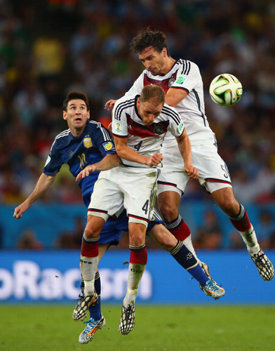  Lionel Messi of Argentina competes for the ball with Benedikt Hoewedes (C) and Mats Hummels of Germany during the final football match between Germany and Argentina for the FIFA World Cup at The Maracana Stadium in Rio de Janeiro on July 13, 2014. Photo: Getty Images