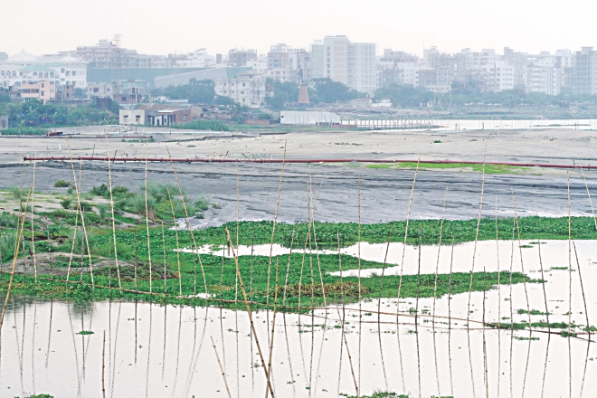 A low-lying area near the Bashundhara housing project being filled with dirt for a real estate project. The photo was taken from near Madani Road in Satarkul of the capital yesterday.  Photo: Star