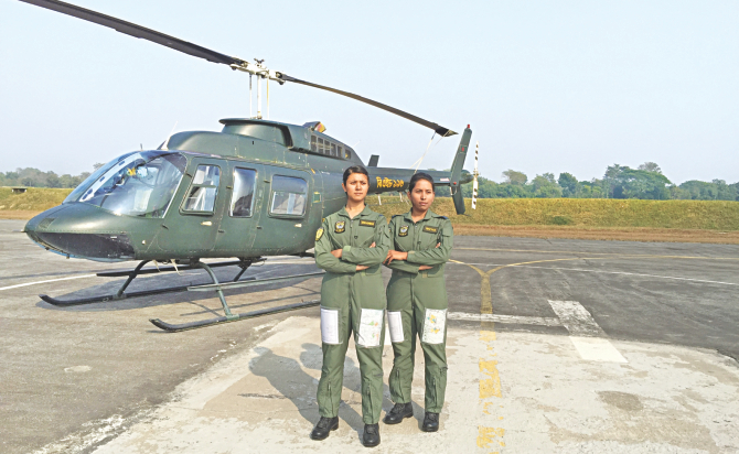 Tamanna and Nayma, right, in front of their Bell 206 helicopter. They have become the first female combat pilots of the Bangladesh Air Force. The photo was taken after they had completed their solo flying test at BAF base Bir Shrestha Matiur Rahman in Jessore.  Photo: Hasan Jahid Tusher 