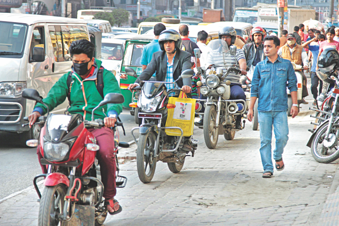 Bike riders plough through the pavement on Kazi Nazrul Islam Avenue in Dhaka, terrifying pedestrians. Little action has been taken since the High Court ordered a stop to such activities in 2012. Photo: Star