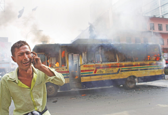 The wailing driver of a bus set on fire allegedly by BNP-led alliance activists in front of Baitul Mukarram National Mosque in the capital on Sunday, on the eve of the political combine's countrywide demonstration yesterday. Photo: Star