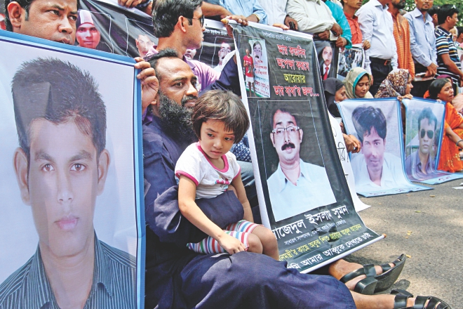 Family members of eight people who had disappeared, including local leader of Ward-38 unit of BNP Sajedul Islam Sumon, form a human chain in front of the Jatiya Press Club yesterday demanding the return of their loved ones. The families claimed that people in Rab uniform had picked them up five months ago. Photo: Anisur Rahman