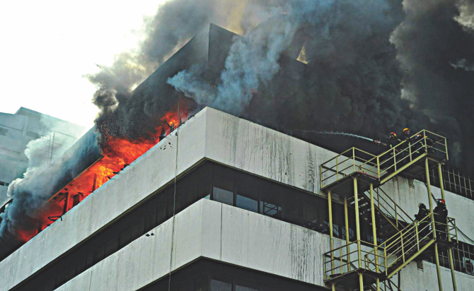 Firefighters in action to put out the flames at the BSEC building at Karwan Bazar in Dhaka yesterday. Photo: Star