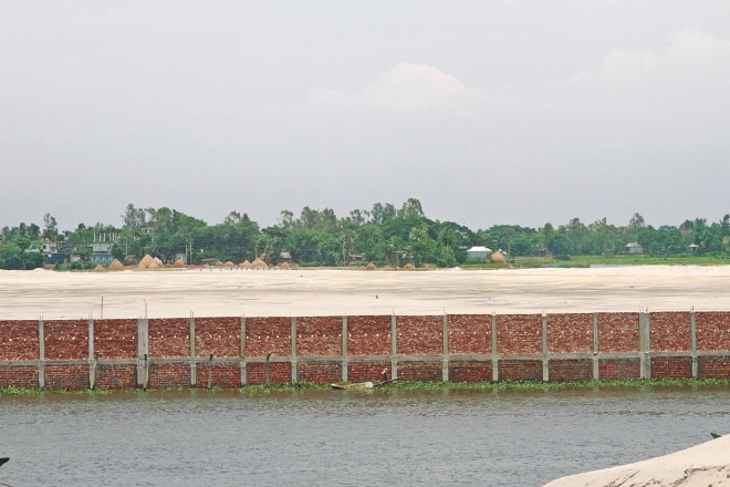 The boundary wall of a housing project built on the flood flow zone near the Balu at the eastern edge of the capital defying the detailed area plan. Photo: Star