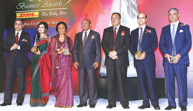From left, Sanjiv Mehta, executive vice president of Unilever South Asia, and managing director and CEO of Hindustan Unilever; Tania Wahab, managing partner of Karigar; Laila Rahman Kabir, managing director of Kedarpur Tea Company; Tofail Ahmed, commerce minister; Desmond Quiah, country manager of DHL Express Bangladesh; Quazi M Shariful Ala, managing director of Delta Brac Housing Finance Corporation; and Yasin Ali, managing director of Habib Group, pose for photographs at the Bangladesh Business Awards ceremony at Sonargaon Hotel in Dhaka on March 28.  PHOTO: Amran Hossain