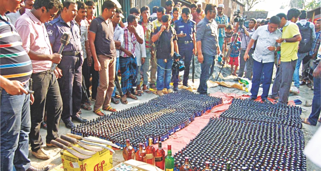 Police seize Phensedyl, foreign liquor and sharp weapons raiding Shimrail Truck Stand in Narayanganj yesterday. The contraband substances were recovered from the shops of Nur Hossain, prime accused in the Narayanganj seven-murder case of last month. Photo: Star