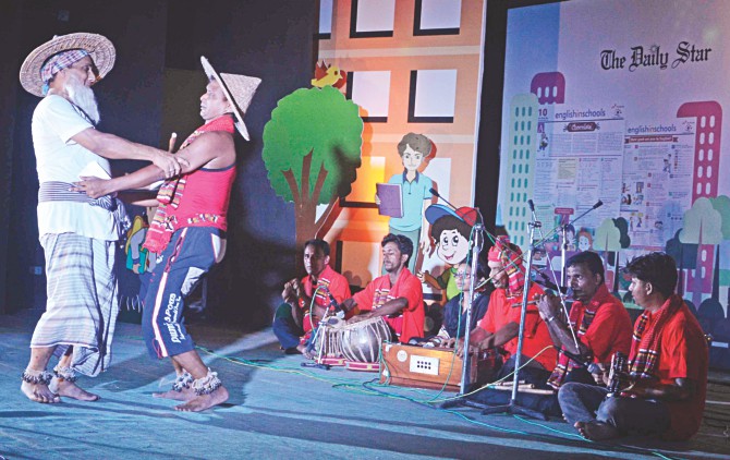 Local artistes performing Gambhira, a popular sub-genre of folk music of Chapainawabganj, in the prize giving ceremony of Rajshahi divisional round of English in Schools, a joint initiative of The Daily Star and Robi, in Kazi Nazrul Islam Auditorium of Rajshahi University yesterday. Photo: Star