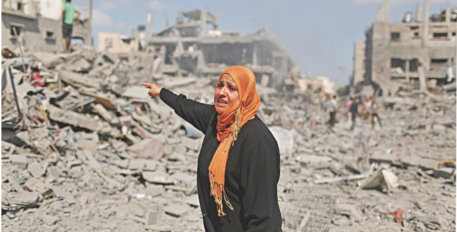 A Palestinian woman reacts as she stands next to her destroyed house in Beit Hanoun town, which witnesses said was heavily hit by shelling and air strikes during the Israeli offensive, in the northern Gaza Strip yesterday.  Photo: Reuters