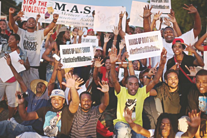 “Hands up, don't shoot”. Ferguson has turned the gesture into a defiant symbol. Photo: Vox.com 