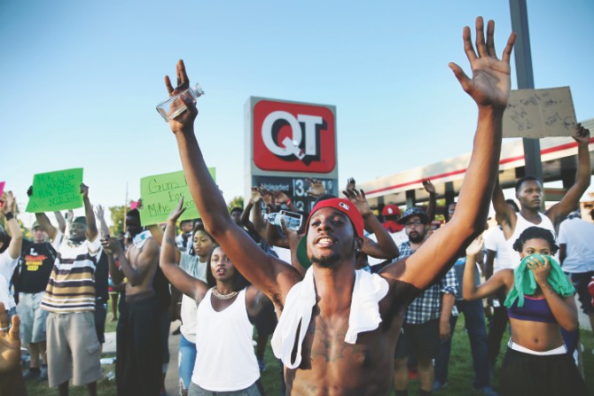 “Hands up, don't shoot”. Ferguson has turned the gesture into a defiant symbol. Photo: Vox.com 