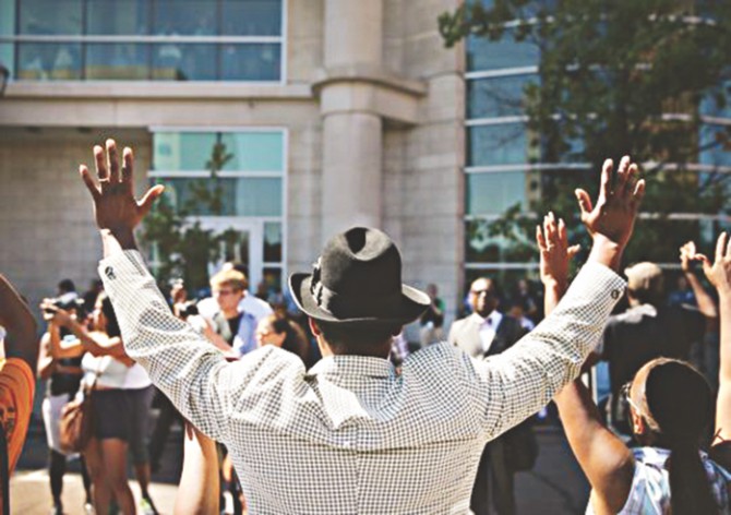 “Hands up, don't shoot”. Ferguson has turned the gesture into a defiant symbol. Photo: Vox.com 