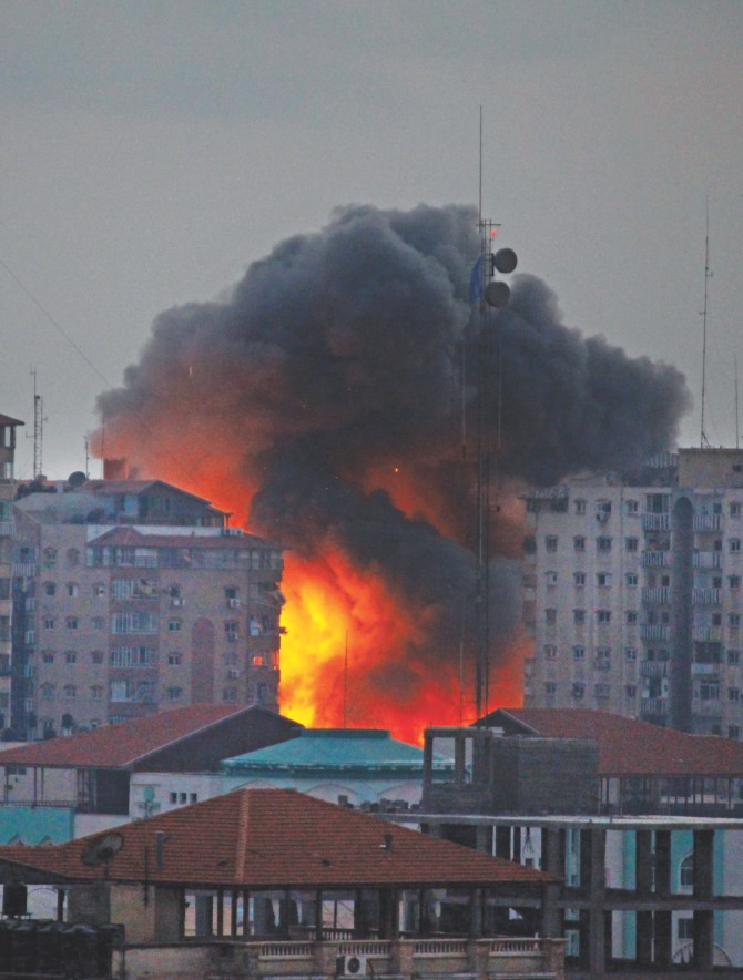 A ball of fire rises from a multi-storey building following an Israeli air strike in Gaza City on Saturday.  Photo: AFP