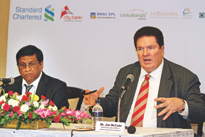 Jim McCabe, CEO of Standard Chartered Bangladesh, speaks at a press conference yesterday to announce Bangladesh Investment Summit to be held in Singapore. Sohail RK Hussain, CEO of City Bank, is also seen. Photo: Star