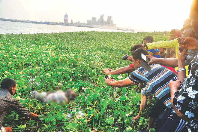 One of the six bodies found in the river Shitalakkhya at Narayanganj is being pulled towards the shore yesterday. The photo was partly pixelated.  Photo: Courtesy/TV grab