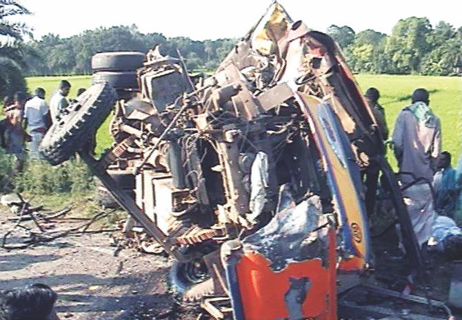 The wreckage of a bus lying by Dhaka-Natore highway after colliding head-on with another bus yesterday afternoon. The accident left 33 passengers dead. Twelve were from Sidhuli village of Gurudaspur upazila alone. Those from Sidhuli were returning from a district court. Photo: TV grab