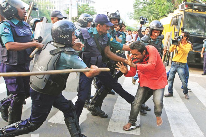Another campaigner being beaten by the anti-riot policemen. Photo: Palash Khan