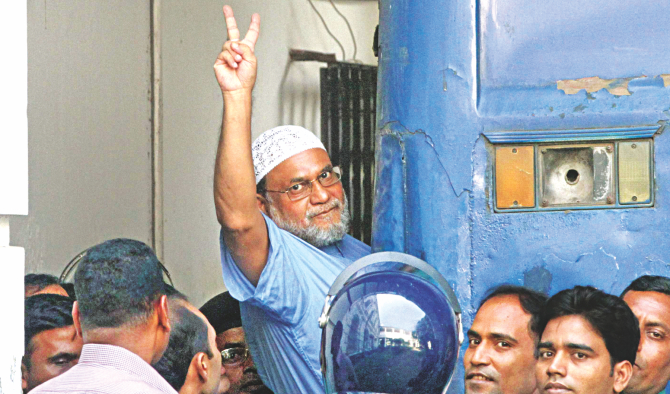 Mir Quasem Ali flashes V-sign as he boards a prison van after International Crimes Tribunal-2 yesterday awarded him death for his 1971 war crimes.  Photo: Amran Hossain