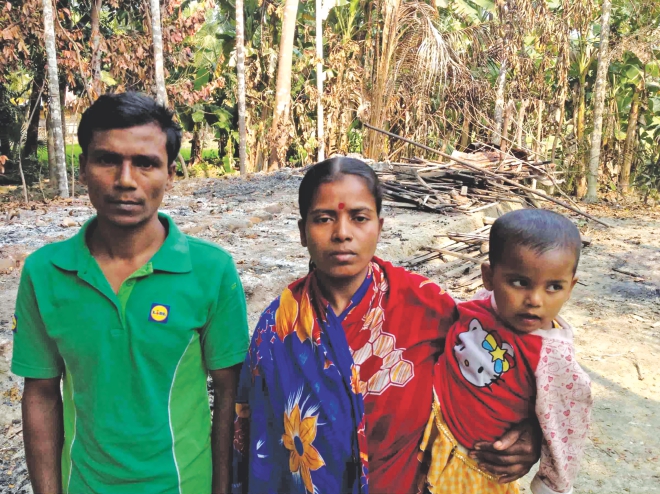 Krishna Haldar and his family standing before their home burnt to the ground at Gabtola Shikdermallik union in Pirojpur. Robbers, allegedly blessed by 18-party alliance men, torched their home during a blockade on December 5.    Photo: TAWFIQUE ALI