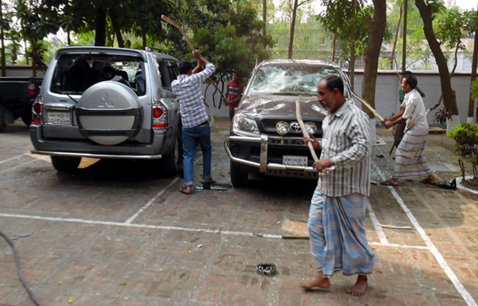 People of Phulbari area in Dinajpur vandalise two vehicles of Asia Energy Corporation (Bangladesh) in front of the company's local office in Phulbari municipality area on Wednesday, protesting the visit of Gary Lye, chief executive officer (CEO) of Asia Energy. Photo: Star