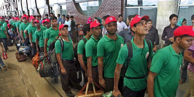 In this Star photo taken on August 27, 2013, Bangladeshi workers stand in line to enter Shahjalal International Airport in Dhaka, before flying to a foreign country for jobs