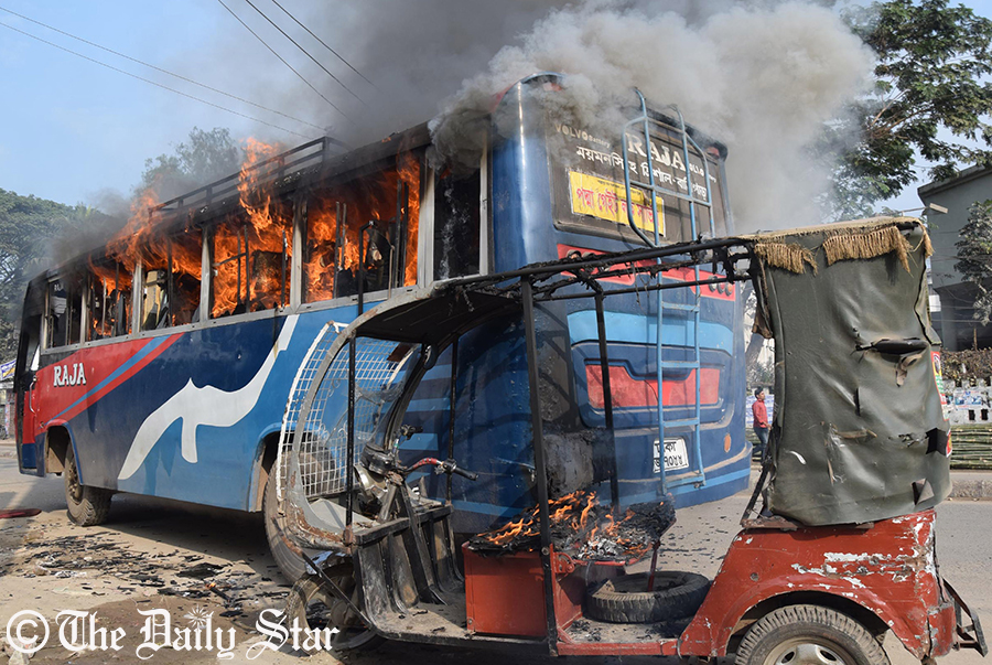 Miscreants set fire to a bus and a CNG-run auto-rickshaw on the Dhaka-Mymensingh highway near Mymensingh Medical College Hospital Sunday. Photo: STAR