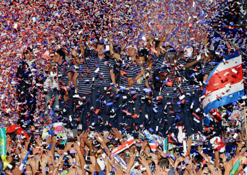 Costa Rican football players wave to fans gathered in San Jose, Costa Rica on July 8, 2014. Photo: Getty Images