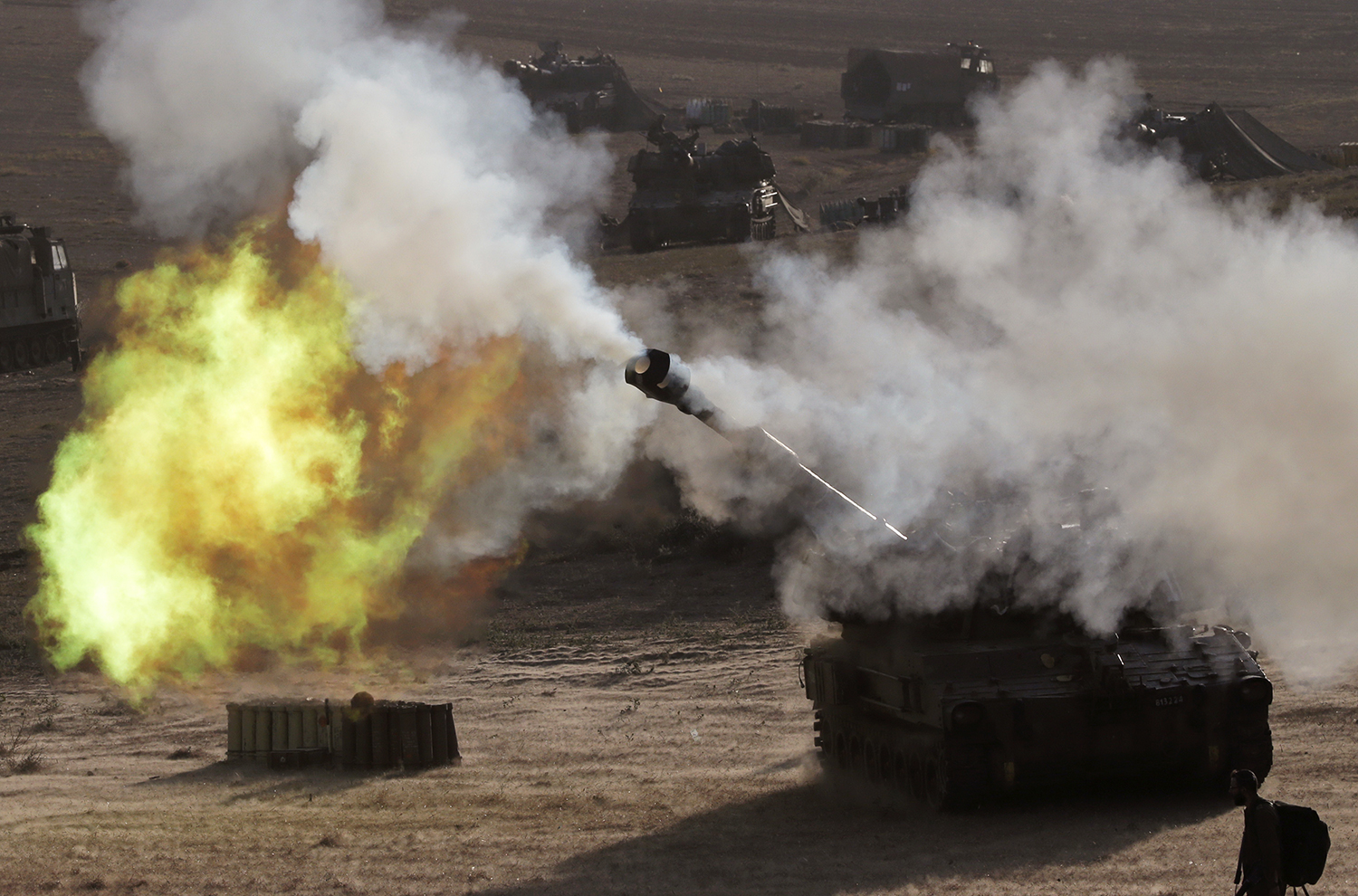 An Israeli tank, positioned near the Israeli border with the Gaza Strip, fires a 155mm projectile towards targets in the Palestinian enclave on July 14, 2014. Photo: Getty Images