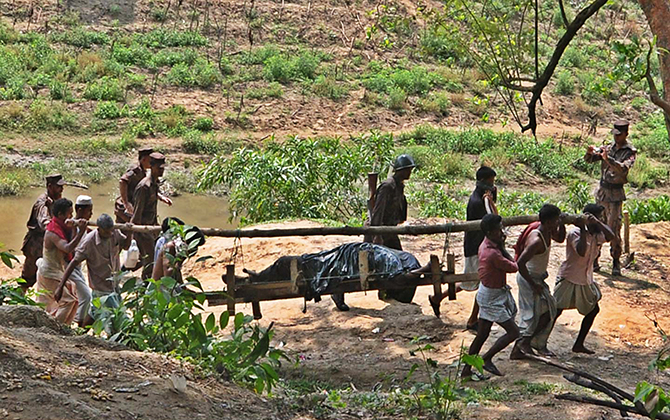 Border Guard Bangladesh members with the help of locals bring the body of their colleague Nayek Mizanur Rahman, killed by Myanmar troops, from frontier area of Bandarban Sunday. Myanmar border guards handed over Mizanur's body Saturday amid high tensions on the border and diplomatic manoeuvres. Photo: Anurup Kanti Das 