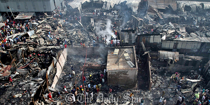 A cihld's body has been recovered from the fire devastated site of a rickshaw garage and adjacent shanties in Moghbazar area of the capital Saturday. Photo: Anisur Rahman