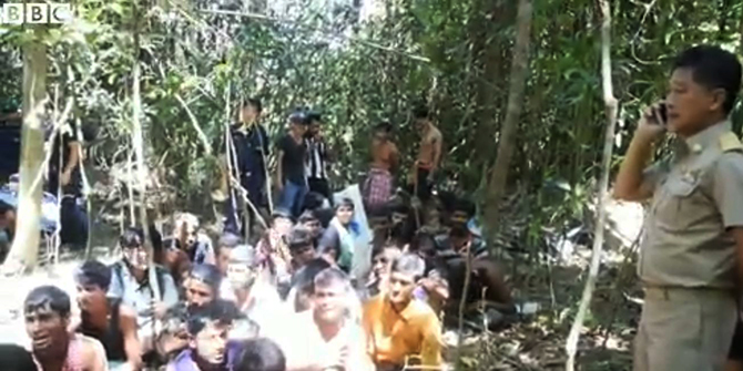 Thailand police arrest a group of Bangladeshi nationals at a rubber plantaion of the country's southern part on October 11. The arrestees were trafficked into the country illegally. Photo grabbed from BBC video 